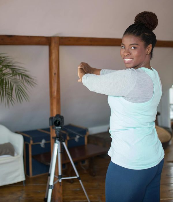 Woman feeling energetic and happy during a morning workout at home.